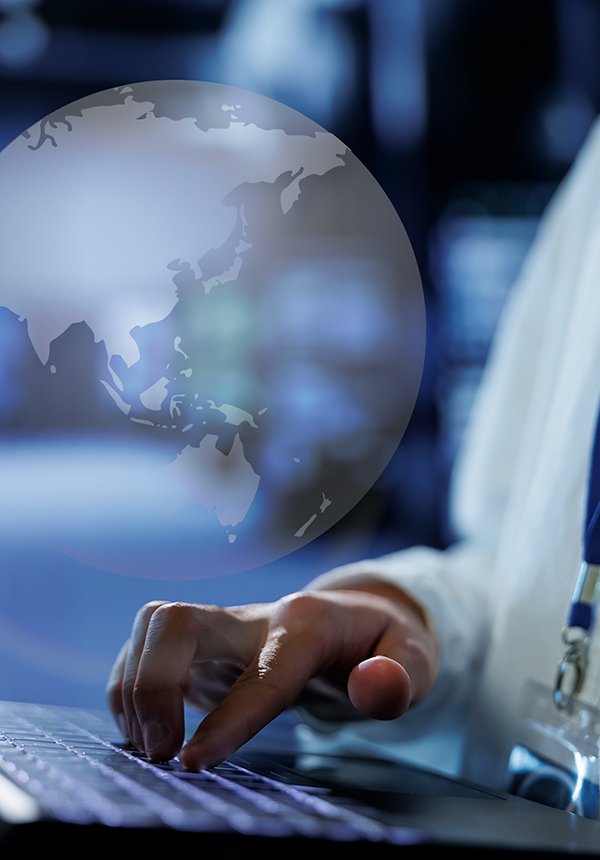 finger on keyboard with asia globe background