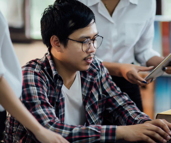 Asian man on computer