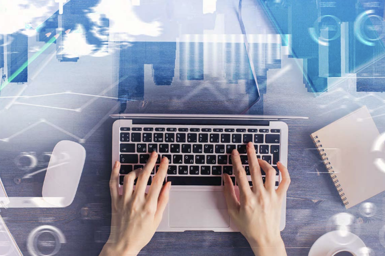 hand typing on laptop keyboard